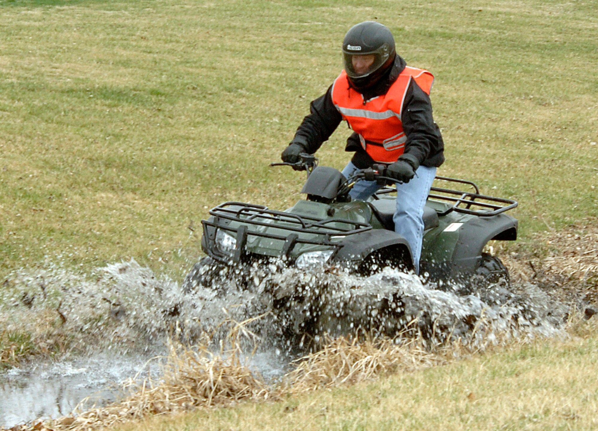 Master Sgt. Scot Steinaway, 22nd Force Support Squadron, splashes through a ditch while riding an all terrain vehicle near at the new Krueger Recreation Area at McConnell Air Force Base, Kan., on March 16. The Area's grand opening, featuring hands-on paintball demonstrations, ATV demonstrations, RC track, and disc golf demonstrations every half hour is scheduled for Saturday from 12:30 p.m. to 3:30 p.m. (U.S. Air Force photo/Senior Airman Laura Suttles)