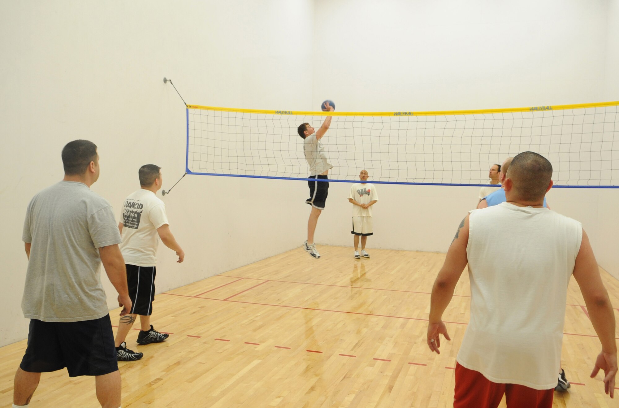 BUCKLEY AIR FORCE BASE,  Colo -- Members of the 460th Contracting Squadron play in a match against the 566th Intelligence Squadron en route to back-to-back wallyball championships, March 27. The Fitness Center hosts monthly lunchtime tournaments to promote fitness and esprit de corps for the troops on base. (U.S. Air Force Photo by Senior Airman Christopher Bush)