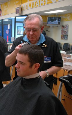 Jim Thul, barber, cuts Airman 1st Class Scott Kelley's hair at the base barber shop March 31. Mr. Thul has been cutting hair at Malmstrom for 50 years as of April 1, 2009. (U.S. Air Force photo/Senior Airman Dillon White)