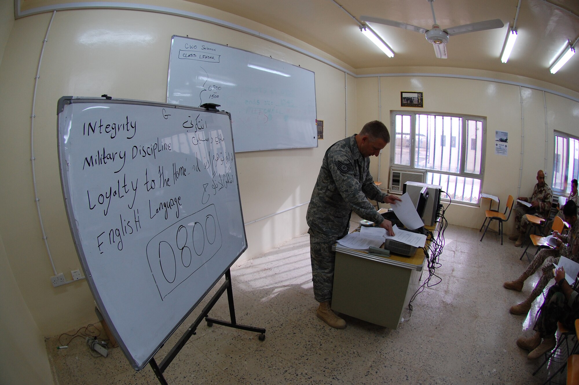 Tech. Sgt. Rick Dunaway prepares to hand out the final test to his Iraqi students March 28 at Camp Taji, Iraq. Twenty-nine Iraqi warrant officers completed the seven-day course where they were taught lessons on discipline, leader influence, teamwork and development, ethics and values, Law of Armed Conflict and problem solving. Sergeant Dunaway is an 821st Expeditionary Training Squadron Iraqi warrant officer professional development course instructor. He is deployed from Maxwell-Gunter Air Force Base, Ala., and is a native of Russellville, Ark. (U.S. Air Force photo/Staff Sgt. Tim Beckham) 
