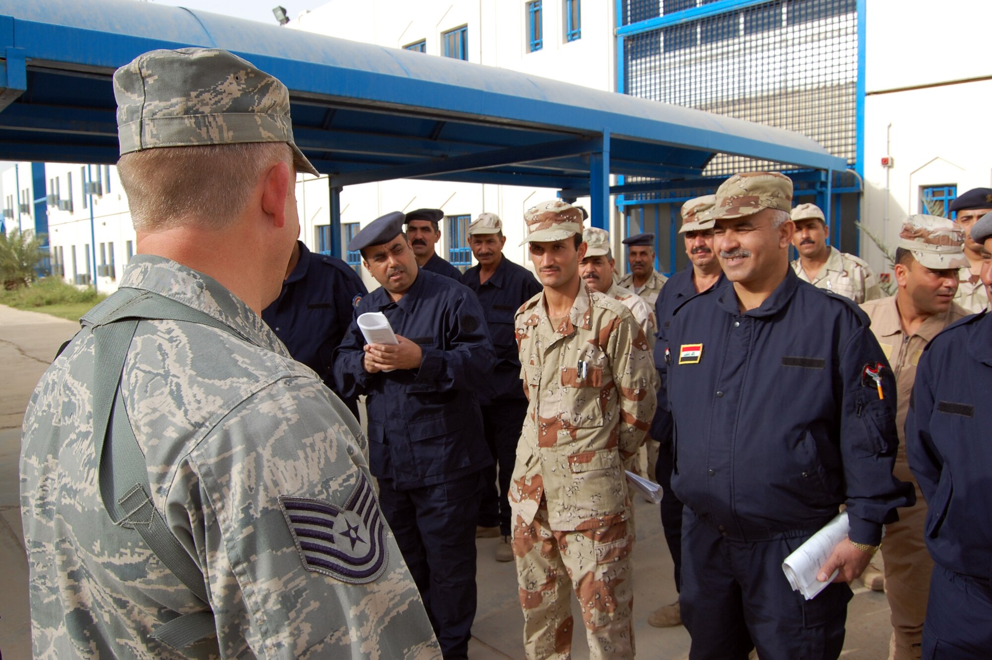 Tech. Sgt. Rick Dunaway briefs students before they take their final exam March 28 at Camp Taji, Iraq. Twenty-nine Iraqi warrant officers completed the seven-day course where they were taught lessons on discipline, leader influence, teamwork and development, ethics and values, Law of Armed Conflict and problem solving. Sergeant Dunaway is an 821st Expeditionary Training Squadron Iraqi warrant officer professional development course instructor. He is deployed from Maxwell-Gunter Air Force Base, Ala., and is a native of Russellville, Ark. (U.S. Air Force photo/Staff Sgt. Tim Beckham) 
