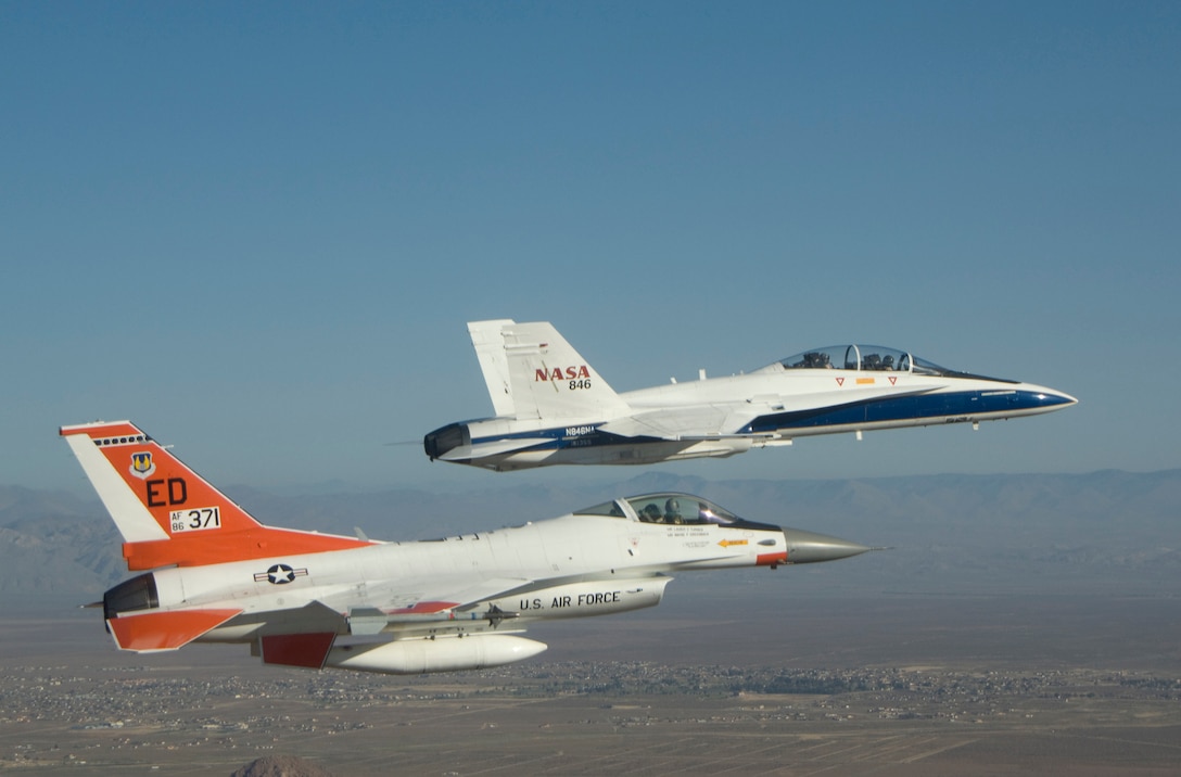 Maj. Gen. David Eichhorn, Air Force Flight Test Center commander, pilots an F-16 Fighting Falcon alongside a NASA F/A-18 Hornet flown by NASA research pilot Frank Batteas during a sortie.  Kevin Petersen, NASA Dryden Flight Research Center director, was in the rear cockpit of the F/A-18 during the mission April 2, the day before he retired from NASA. (NASA photo/Jim Ross) 