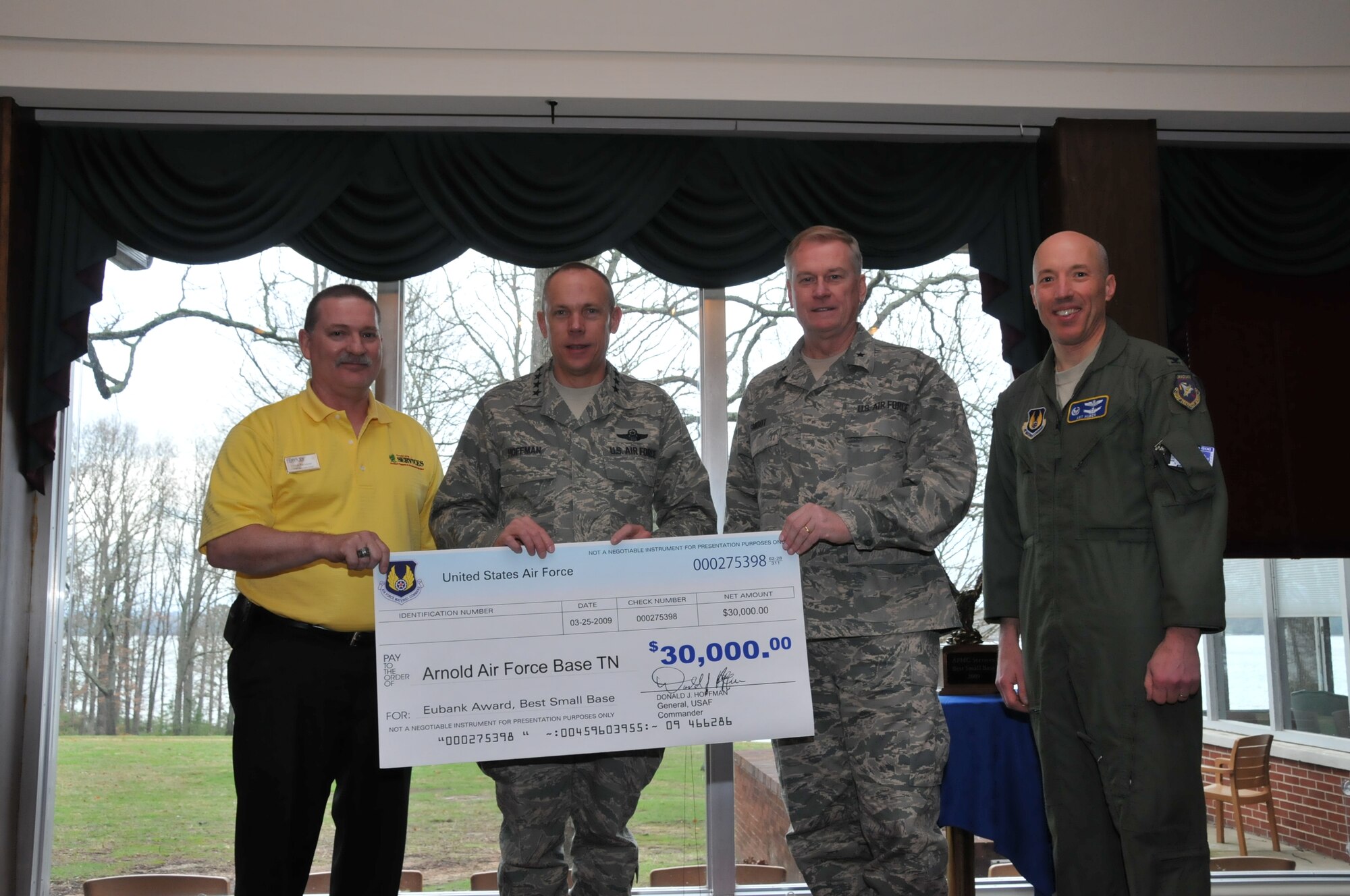 AFMC Commander Gen. Donald Hoffman, second from left, and AFMC Director of Military Personnel and Services Brig. Gen. Marvin T. “Tom” Smoot, third from left, present Rick Ferrebee, 704th Services chief, with a check for the monetary portion of the AFMC Eubank Award for 2008. The Eubank Award recognizes excellence in Services Squadrons at small installations. The award was given the name of Maj. Gen. Eugene L. Eubank, a decorated Air Force veteran who was a strong proponent and supporter of quality of life programs for Air Force members and their families. Arnold’s Services Squadron also won the AFMC Eubank award for 2006. AEDC Commander Col. Art Huber is pictured on the right. (Photo by David Housch)