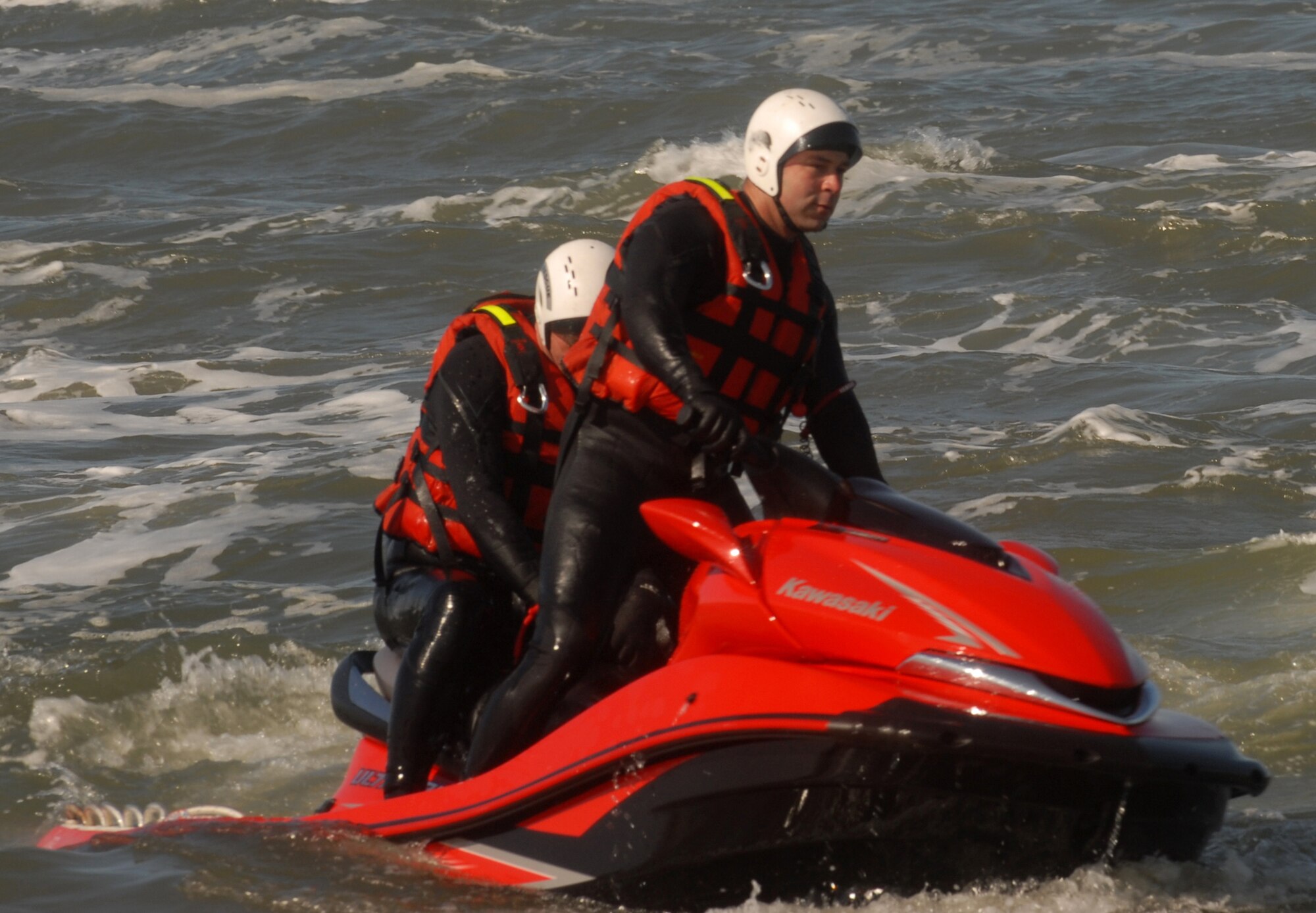 VANDENBERG AIR FORCE BASE, Calif.-- Racing across the cresting waves, Staff Sgt. Nathan Duncan and Fire Captain Bill Burch, both Vandenberg firefighters, demonstrate a pick off during water rescue training March 31 at Wall Beach here.  The training allows the rescue team to familiarize themselves with the currents and tides of Vandenberg's beaches.  (U.S. Air Force photo/Airman 1st Class Antoinette  Lyons)
