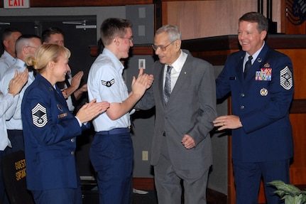 Chief Master Sgt. of the Air Force Paul W. Airey greets Airman 1st Class Matthew Shaffer and Chief Master Sgt. Pamela Derrow following a presentation in 2008. Escorting Chief Airey is current Chief Master Sgt. of the Air Force Rodney J. McKinley. Chief Airey passed away March 11. Chief Airey was the first chief master sergeant of the Air Force, Chief Derrow is the U.S. Air Forces in Europe command chief. (Courtesy photo) 
