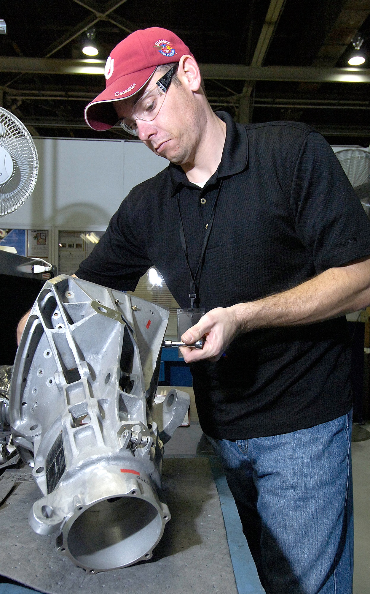 Mike Boettler installs a scuff plate back into an F-15’s air refueling receptacle. (Air Force photo/Margo Wright)