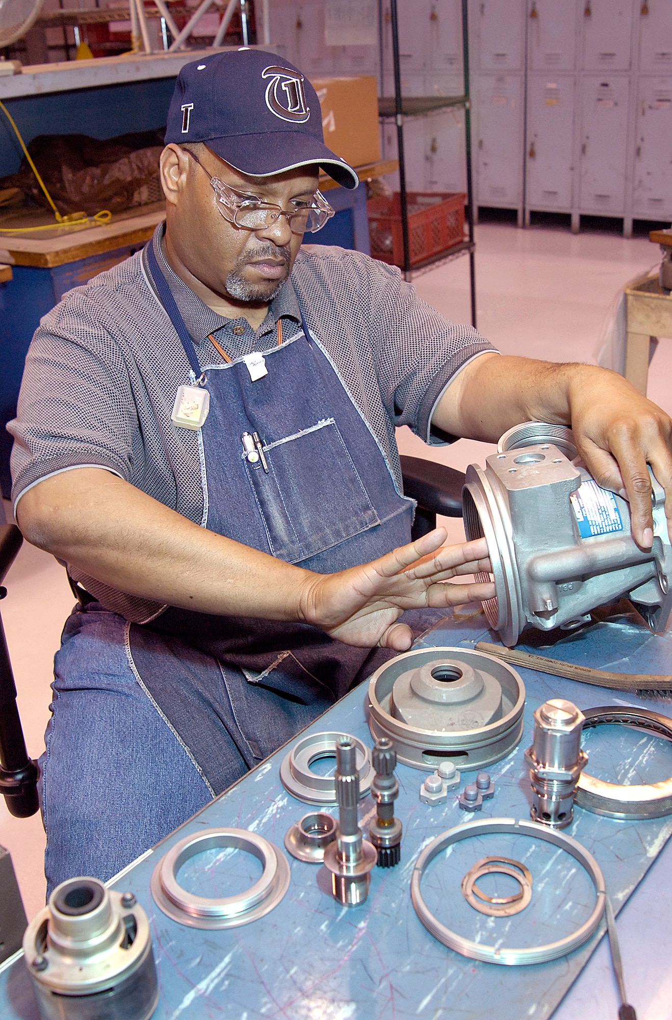 Maurice Trice feels for remaining rough places after filing smooth an area on an F101 main fuel pump. The pneudraulics systems mechanic and others in the shop disassemble components down to tiny pins and springs, then clean, repair, reassemble and test components from several aircraft and engines.