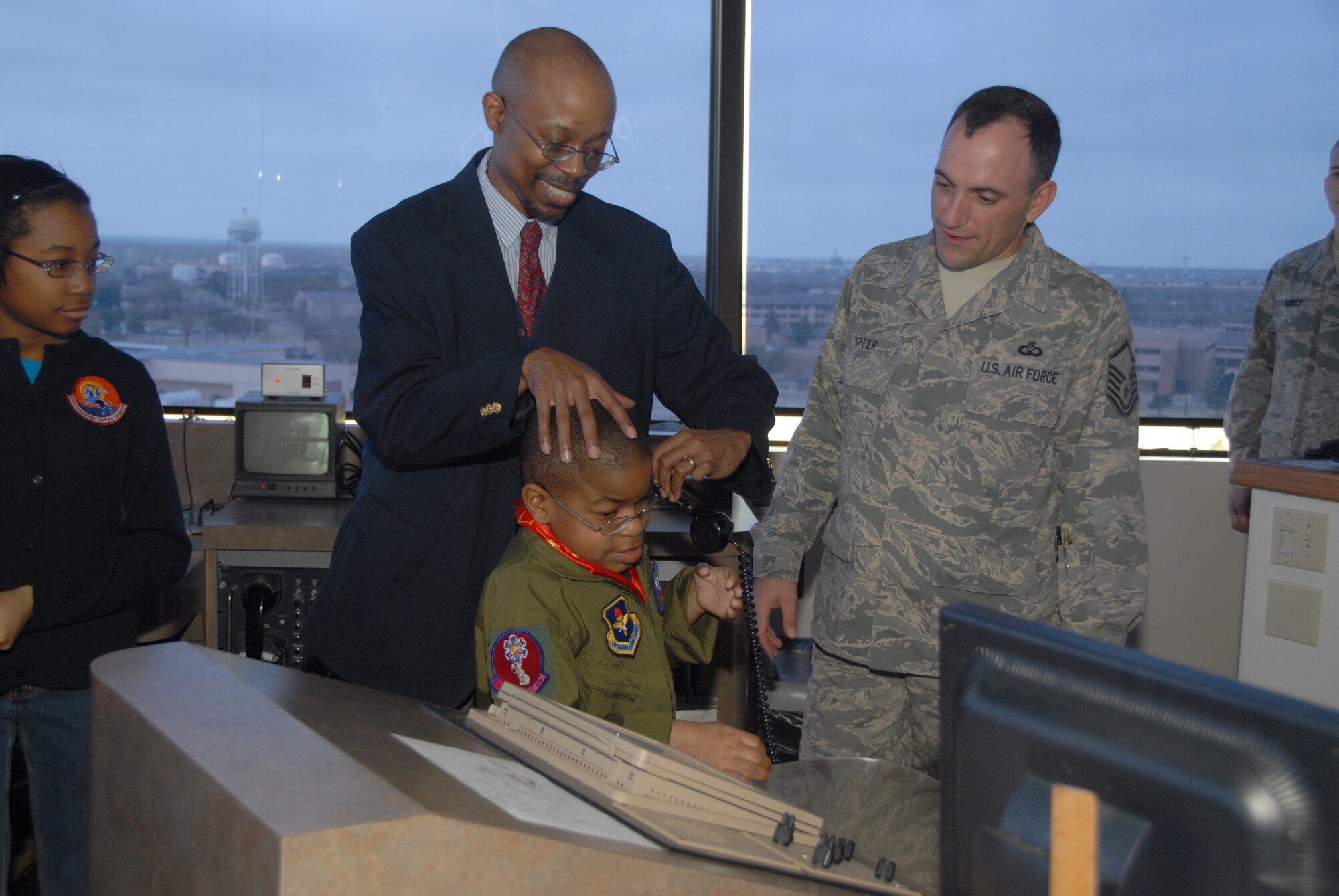 ALTUS AIR FORCE BASE, Okla. -- Greg and Xavier Willis speak to a C-17 pilot from the control tower during the "Pilot for a Day" event March 20. (U.S. Air Force photo/Senior Airman Jennifer L. Flores)
