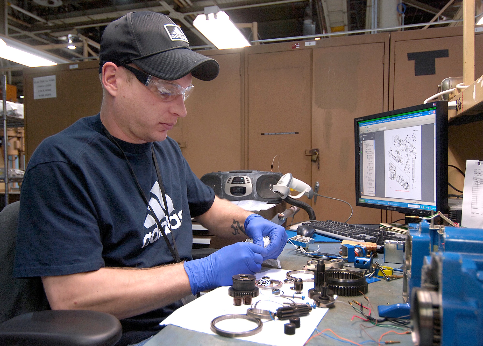 Mark Loser tears down a rotary actuator for a C-5 that opens and closes to help pressurize the aircraft.  Tiny pins and wafer-thin rings are important pieces with each being critical to an aircraft’s safe operation. The electrical equipment repairer in the Electrical Accessories Section will clean, replace and reassemble this and other components from a variety of weapons systems. (Air Force photo/Margo Wright)