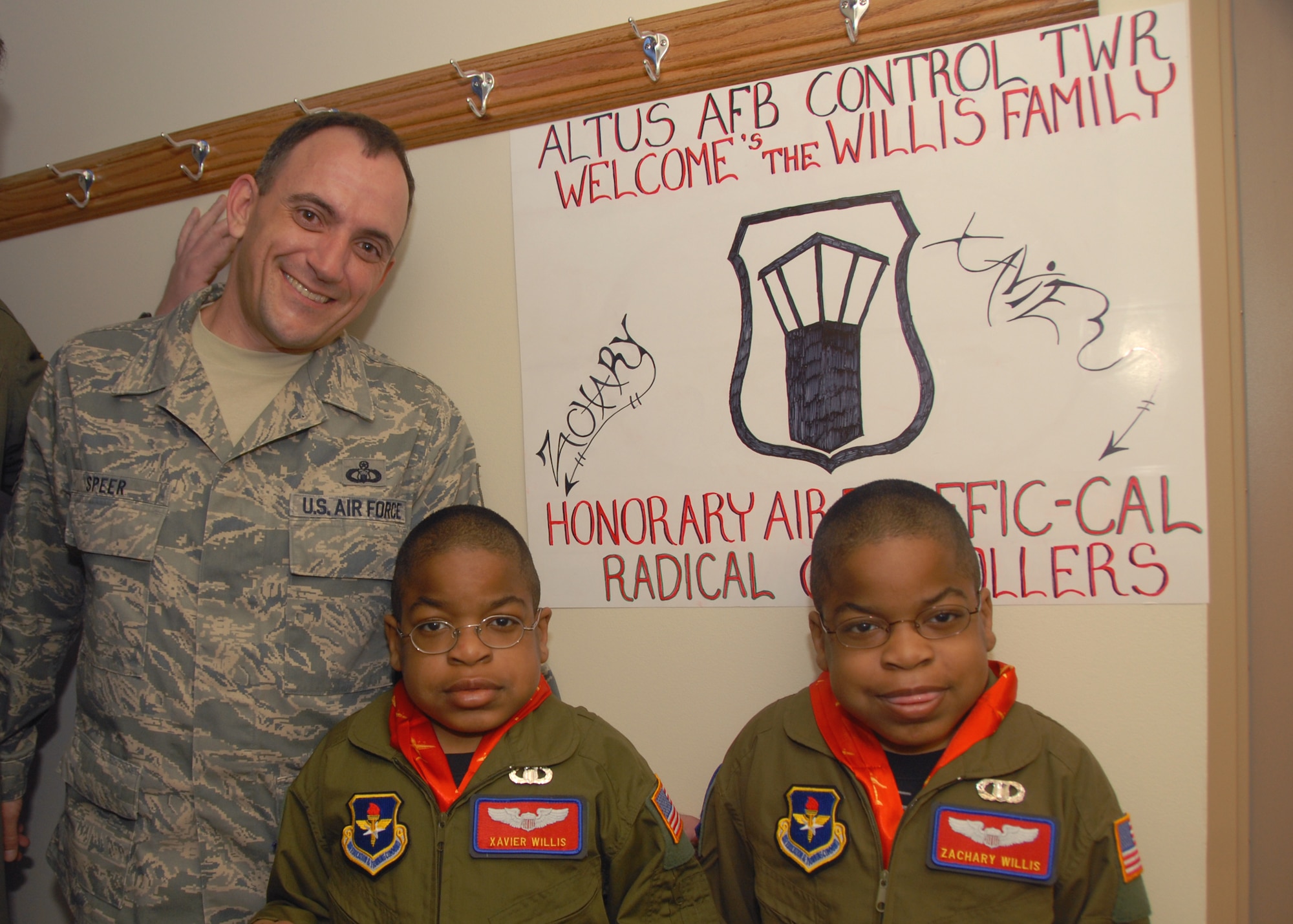 ALTUS AIR FORCE BASE, Okla. -- Master Sgt. Christopher Speer, 97th Operations Support Squadron, poses with Xavier and Zachary Willis during the "Pilot for a Day" event. Sergeant Speer gave the Willis family a tour of the control tower. (U.S. Air Force photo/Senior Airman Jennifer L. Flores)