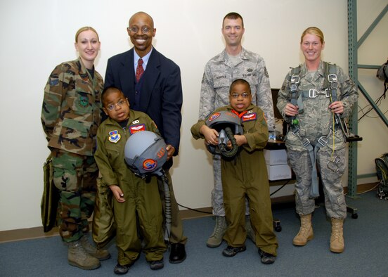 ALTUS AIR FORCE BASE, Okla. -- Xavier, Zachary and Greg Willis pose with members of the life support section during the "Pilot for a Day" event. (U.S. Air Force photo/Senior Airman Jennifer L. Flores)