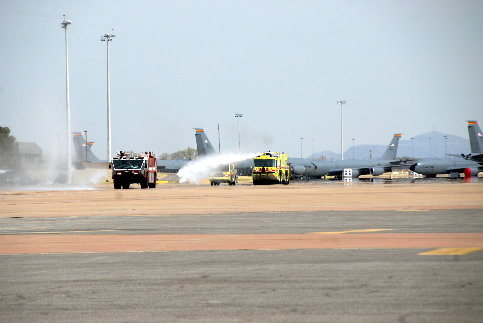 ALTUS AIR FORCE BASE, Okla. -- Xavier and Zachary Willis enjoy shooting water from fire trucks while riding out to a C-17 static display. The brothers rode in the trucks as part of the "Pilot for a Day" event March 20. (U.S. Air Force photo/Senior Airman Jennifer L. Flores)