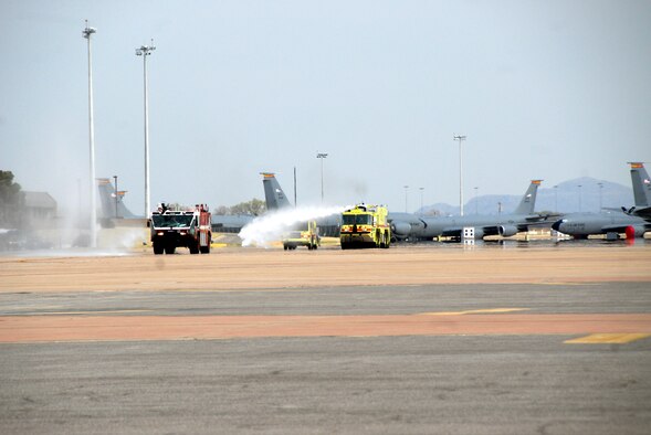 ALTUS AIR FORCE BASE, Okla. -- Xavier and Zachary Willis enjoy shooting water from fire trucks while riding out to a C-17 static display. The brothers rode in the trucks as part of the "Pilot for a Day" event March 20. (U.S. Air Force photo/Senior Airman Jennifer L. Flores)