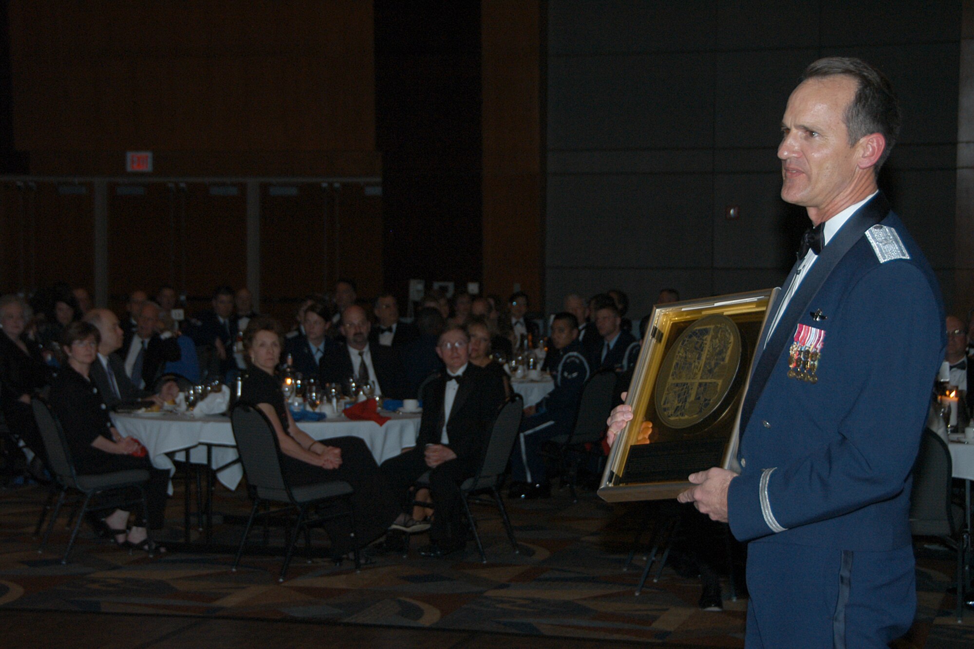 OFFUTT AIR FORCE BASE, Neb. -- Brig. Gen. James Jones, 55th Wing commander,  announces the 55th Wing spouses past and present as honorary 55th Wing Hall of Fame members during the 55th Wing's annual Birthday Ball at the Qwest Center March 28. The wing's spouses were honored for their past, present and future contributions that have the Airmen of the "Fightin' Fifty-Fifth" ready to answer their nation's call. Air Force Photo by Jeff Gates                                      