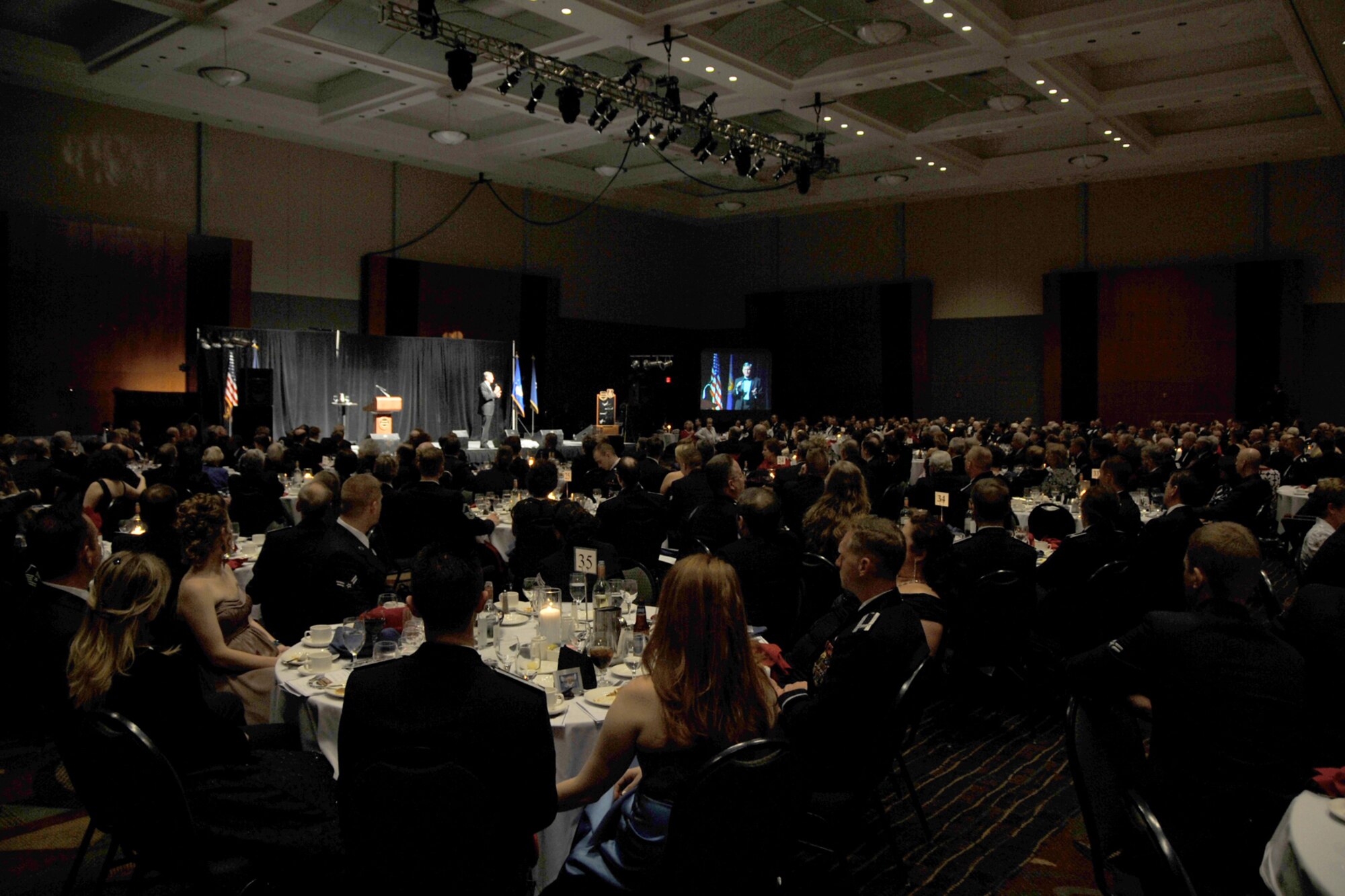 OFFUTT AIR FORCE BASE, Neb. -- Patrons listen to retired Lt Gen. Walter E. Buchanan III the honorary guest speaker as he gives words of encouragement to military members, spouses and civilian guests at the 2009 Birthday Ball held at the Qwest Center March 28.

 Air Force Photo by Jeff Gates