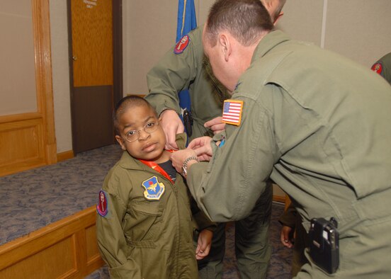 ALTUS AIR FORCE BASE, Okla. -- Col. Stuart Shaw, 97th Air Mobility Wing vice commander, pins pilot wings on Zachary Willis, one of the "Pilot for a Day" participants. (U.S. Air Force photo/Senior Airman Jennifer L. Flores)
