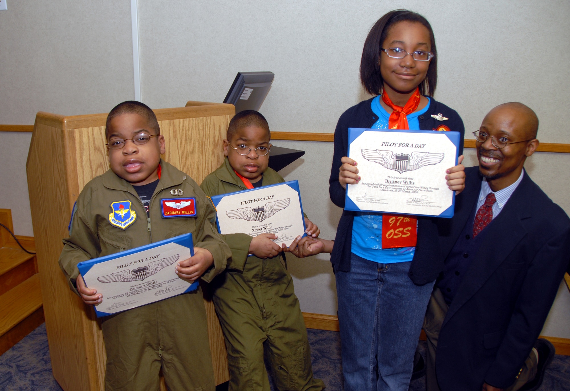 ALTUS AIR FORCE BASE, Okla. -- Zachary, Xavier and Brittney Willis display the wings and certificates they received as participants of the "Pilot for a Day" program as their father Greg looks on. (U.S. Air Force photo/Senior Airman Jennifer L. Flores)