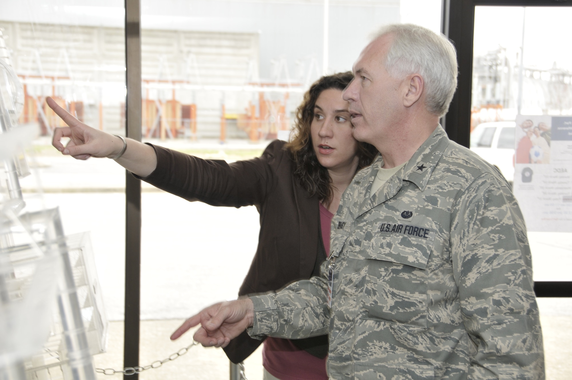 Stephanie Warren, Aerospace Testing Alliance Public Affairs tour coordinator, explains to Brig. Gen. Dwight Creasy, Air Force Materiel Command Staff Judge Advocate, how the Propulsion Wind Tunnel complex operates. General Creasy and Chief Master Sgt. Jack Craft, AFMC paralegal manager, visited Arnold Engineering Development Center as a part of the general’s Staff Assistance Visit of the AEDC Legal Office. (Photo by Rick Goodfriend)