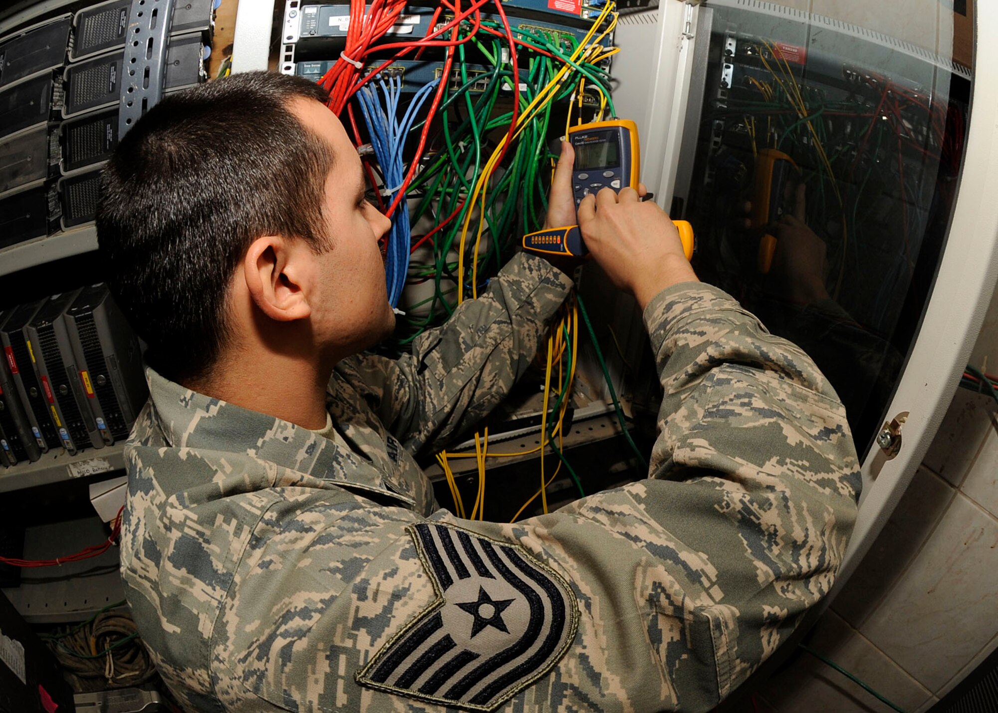 Tech. Sgt. Matthew Reyes, NCIOC of J6 Task Force 134, uses a flute tester and a toner kit to test the connectivity of the network at their facility at Camp Liberty, Iraq April 1, 2009. Sergeant Reyes is a member of Task Force 134 which is responsible for all Iraqi detainee operations throughout Iraq. Sergeant Reyes is deployed from Edwards AFB, Calif., and a native of Sacramento, Calif. (U.S. Air Force photo by Senior Airman Jacqueline Romero)