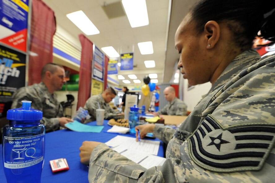MINOT AIR FORCE BASE, N.D. – Tech. Sgt. Barbra Wilson, 5th Medical Operations Squadron’s noncommissioned officer in charge of alcohol and drug abuse prevention team, grades an anonymous alcohol screening form during a National Alcohol Screening Day event at the base exchange here April 2. By completing this alcohol self-assessment, Airmen can potentially prevent unhealthy drinking habits before they start.  (U.S. Air Force photo by Senior Airman Kelly Timney)