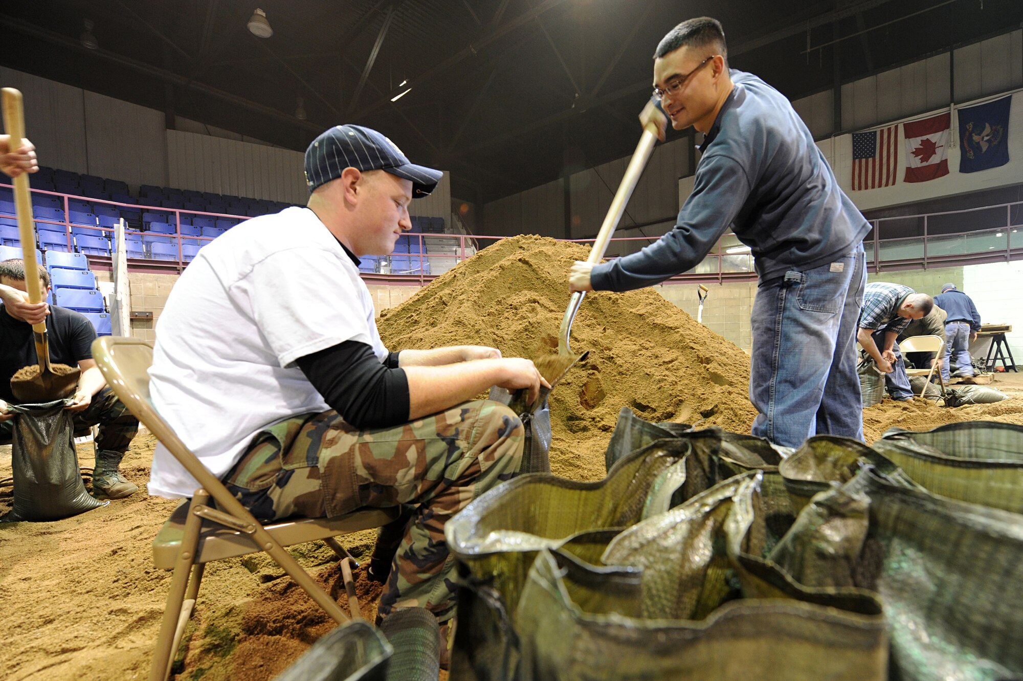 MINOT, N.D. – Ammo Airmen from the 5th Munitions Squadron fill sand bags for the second day in a row as they aid the local Minot community in building sand bags in the All Season’s Arena here April 1. Volunteers from the Minot area community and Minot Air Force Base reached the goal of filling 25,000 sandbags in the first two days alone. They will continue to help in this flood relief effort until 6 p.m. April 4. (U.S. Air Force photo by Senior Airman Kelly Timney)