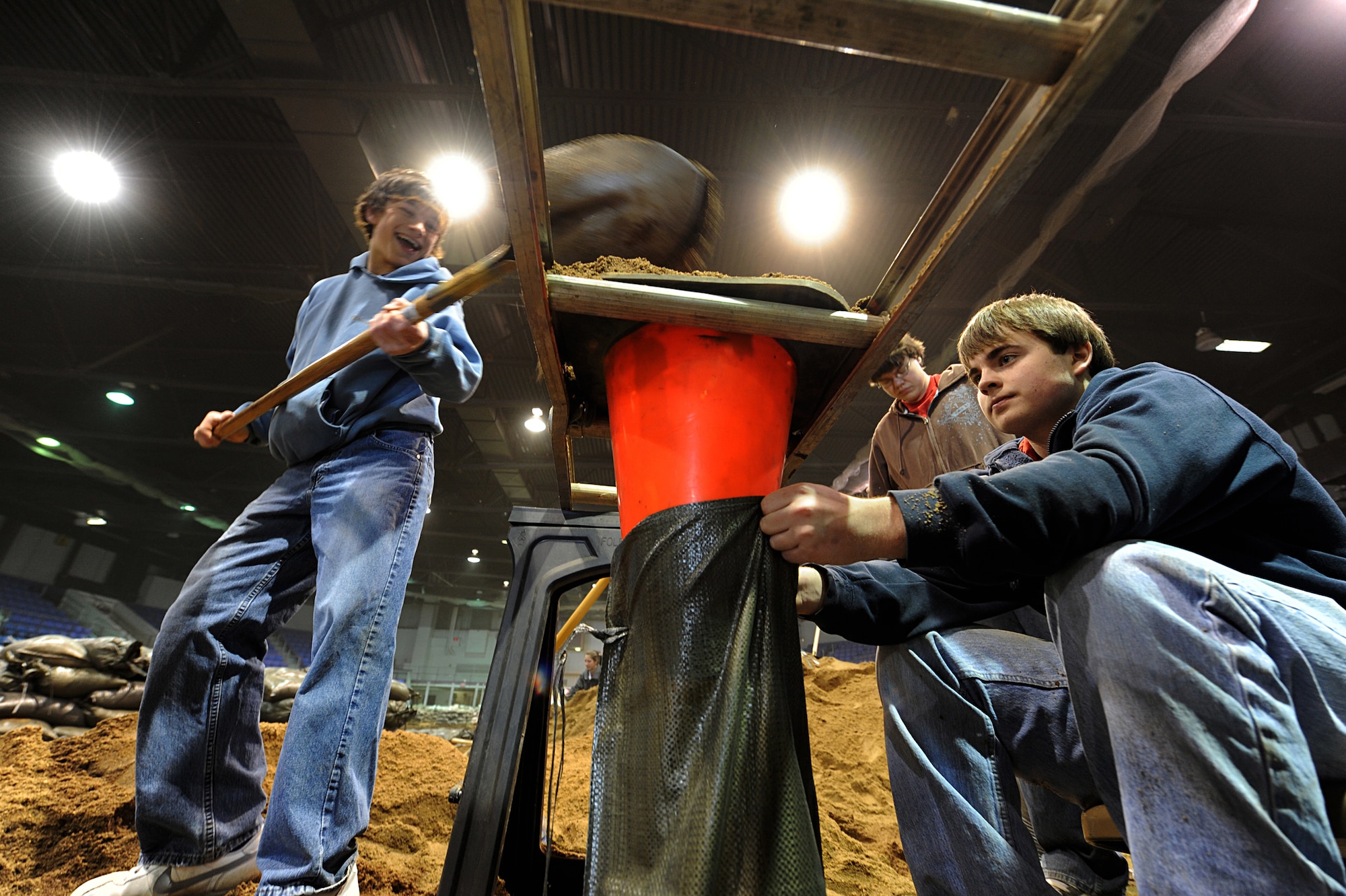 MINOT, N.D. – Members from the Bishop Ryan High School varsity baseball team help fill sand bags in Minot city’s All Season’s Arena here April 1. Volunteers from the Minot area community and Minot Air Force Base reached the goal of filling 25,000 sandbags in the first two days alone. They will continue to help in this flood relief effort until 6 p.m. April 4. (U.S. Air Force photo by Senior Airman Kelly Timney)