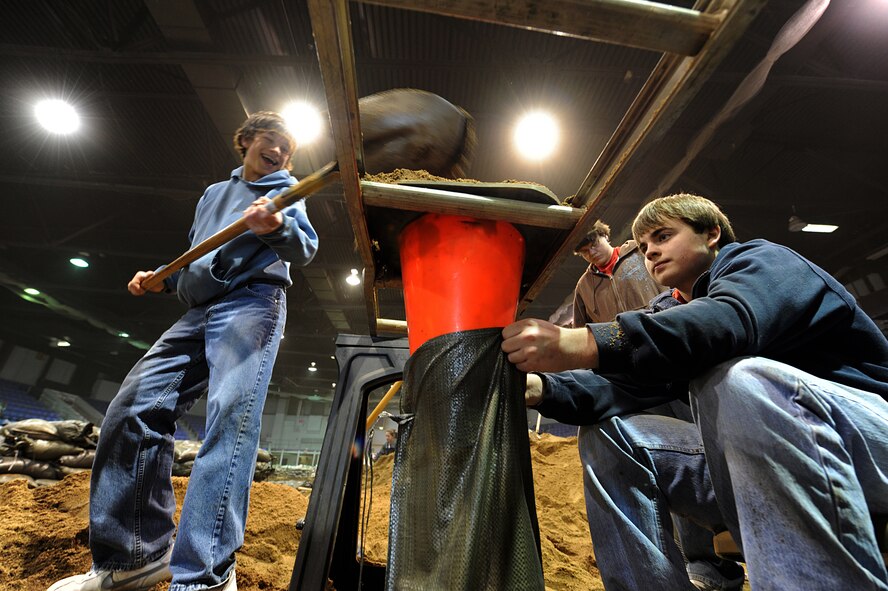 MINOT, N.D. – Members from the Bishop Ryan High School varsity baseball team help fill sand bags in Minot city’s All Season’s Arena here April 1. Volunteers from the Minot area community and Minot Air Force Base reached the goal of filling 25,000 sandbags in the first two days alone. They will continue to help in this flood relief effort until 6 p.m. April 4. (U.S. Air Force photo by Senior Airman Kelly Timney)