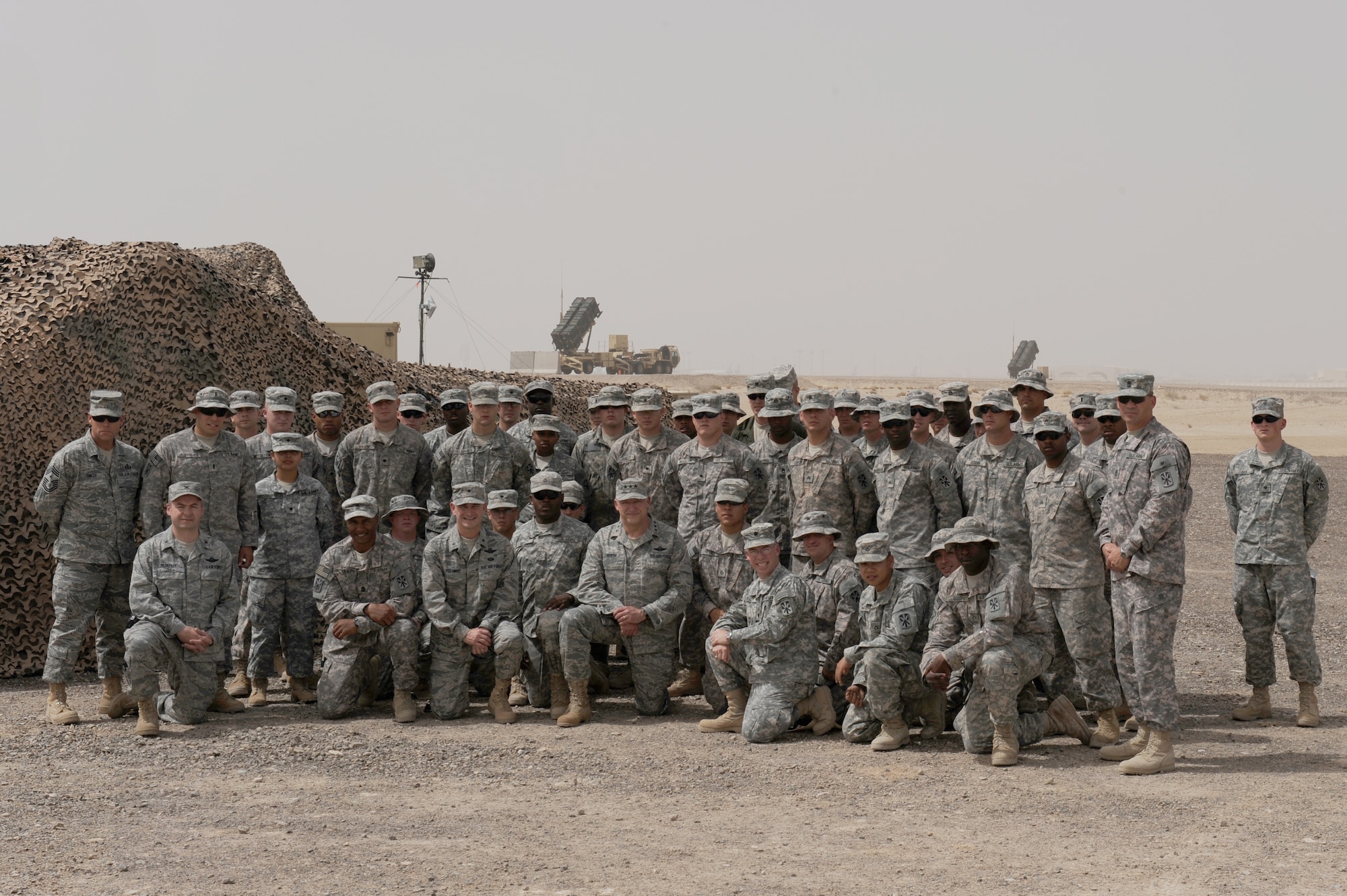 SOUTHWEST ASIA - Lt. Gen. Gary North, U.S. Air Forces Central, commander stops to take a group photo with Soldiers and wing leadership at the 380th Air Expeditionary Wing, April 1. General North met with Soldiers and Airman on his visit and talked with them on the importance of what each individual does and the value everyone brings to the fight. This was General North's first visit to the newly added Patriot Battery site.  (U.S. Air Force photo by Senior Airman Brian J. Ellis) (Released)