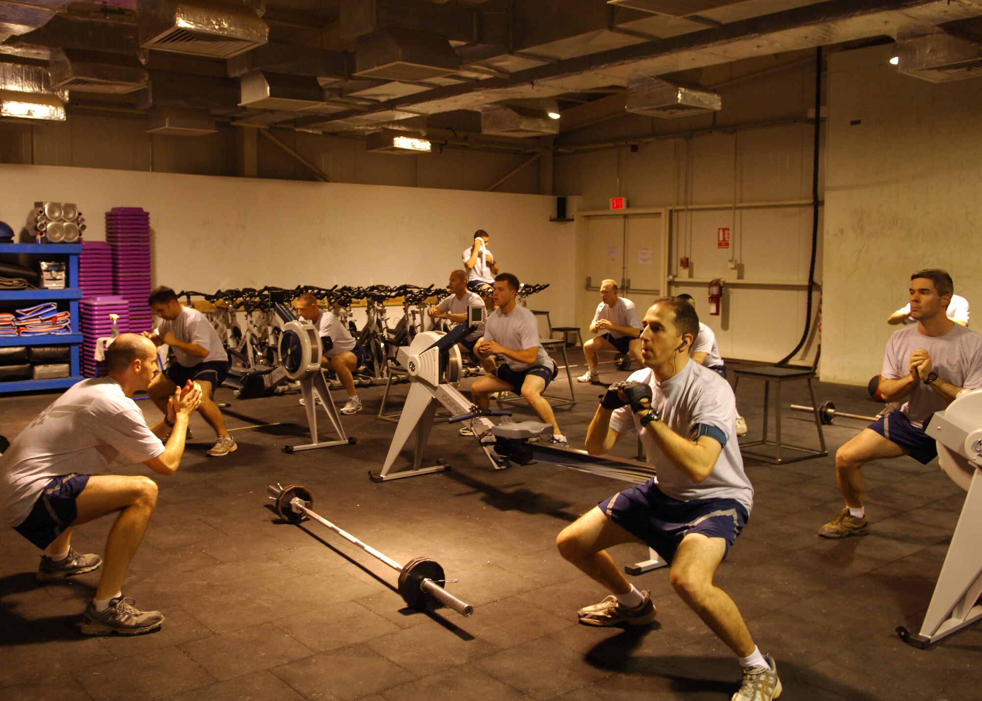 JOINT BASE BALAD, Iraq ? Led by Maj. Jeff Queen, 332nd Expeditionary Operations Support Squadron director of operations, who volunteers as a CrossFit instructor here, servicemembers participate in a daily CrossFit class March 9. CrossFit is one of various strength and conditioning programs offered at the Red Tail Fitness Center here. Major Queen is deployed here from Keesler AFB, Miss., and is from Montgomery, Ala. (U.S. Air Force photo/Staff Sgt. Dilia Ayala)