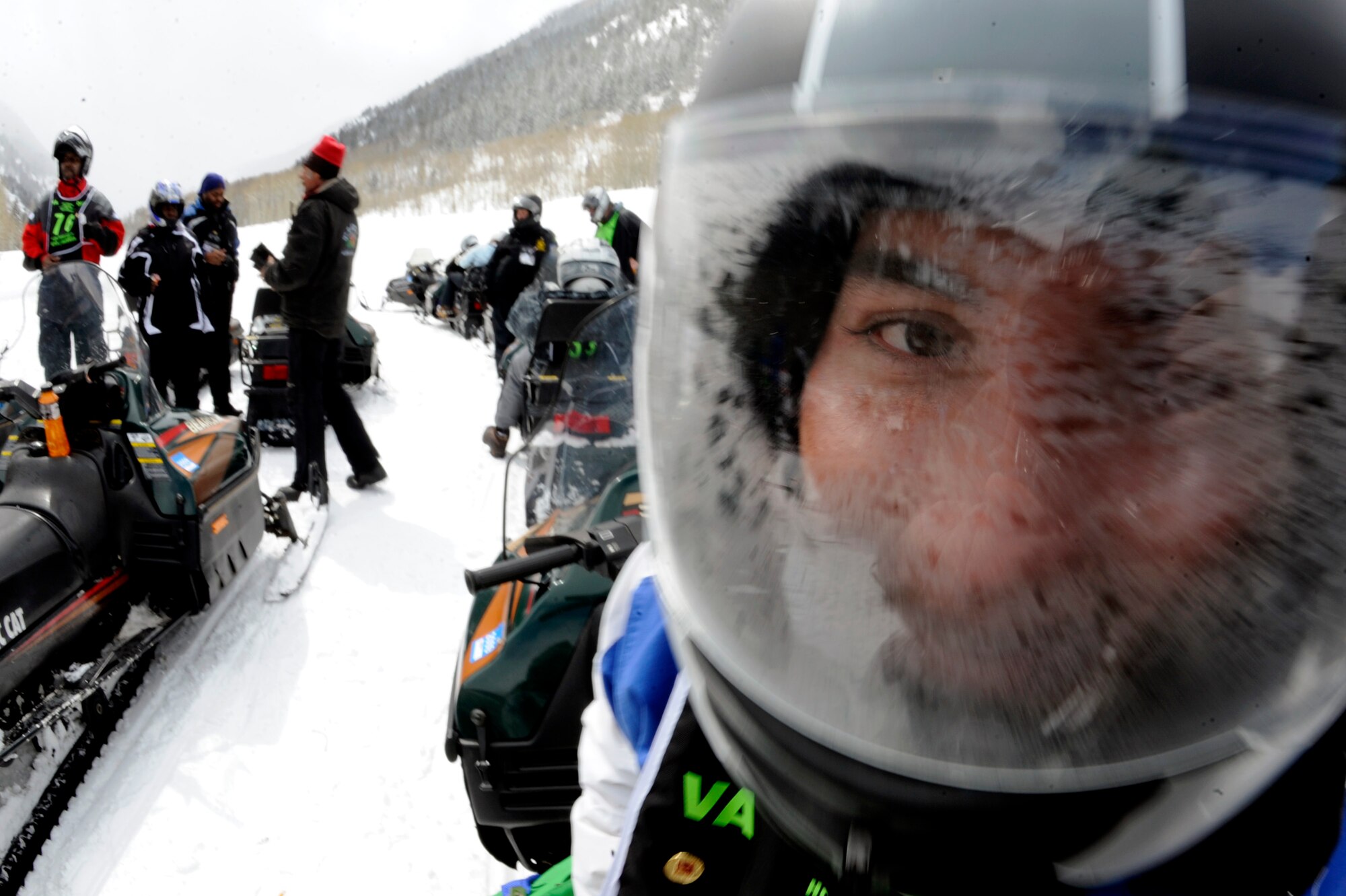 Senior Airman Kevin Krogh fogs up his helmet during a hot cider break after driving a snowmobile Apr. 1 during the 23rd National Disabled American Veterans Winter Sports Clinic in Snowmass Village, Colo. Airman Krogh lost both legs in a major car accident in 2007 and this is his first year attending the sports clinic. Airman Krogh is assigned to Fort Sam Houston in San Antonio.  (U.S. Air Force photo/Staff Sgt. Desiree N. Palacios)