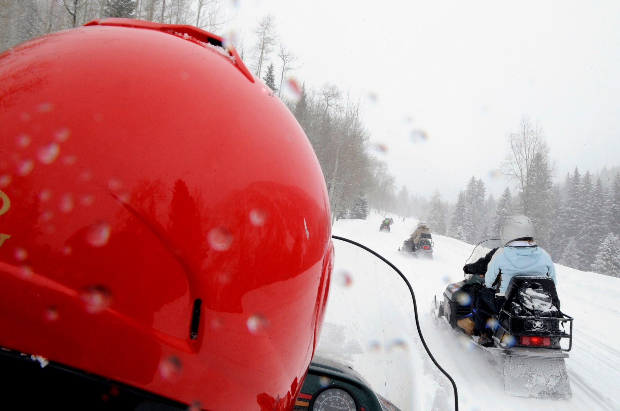 Veterans drive snowmobiles Apr. 1 during the 23rd National Disabled American Veterans Winter Sports Clinic in Snowmass Village, Colo.  The six-day event that began March 28 teaches veterans with disabilities skills in adaptive Alpine and Nordic skiing, and introduces them to a number of other recreational activities and sports.  (U.S. Air Force photo/Staff Sgt. Desiree N. Palacios)
