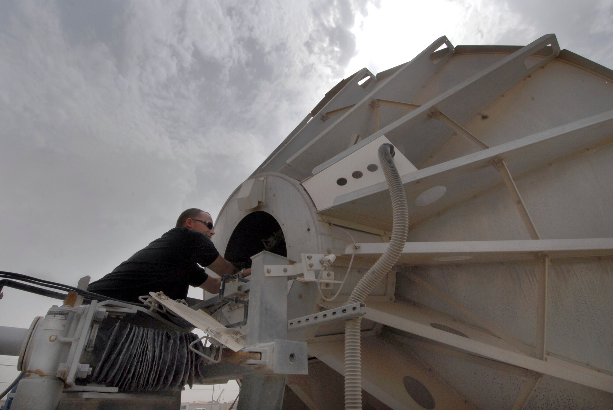 Mike Kaupp, DRS Technologies Site Manager, checks a feed in the low noise amplifier on a communications antenna, Mar. 30, 2009, at an undisclosed location in Southwest Asia.  Mr. Kaupp is from San Clemente, Calif. and is part of the 379th Expeditionary Communications Squadron Technical Control.  The unit supports 75% of the communications for the Air Force throughout the U.S. Central Command's Area of Responsibility to support Operations Iraqi and Enduring Freedom and Combined Joint Task Force - Horn of Africa.  (U.S. Air Force photo/Senior Airman Andrew Satran/released)