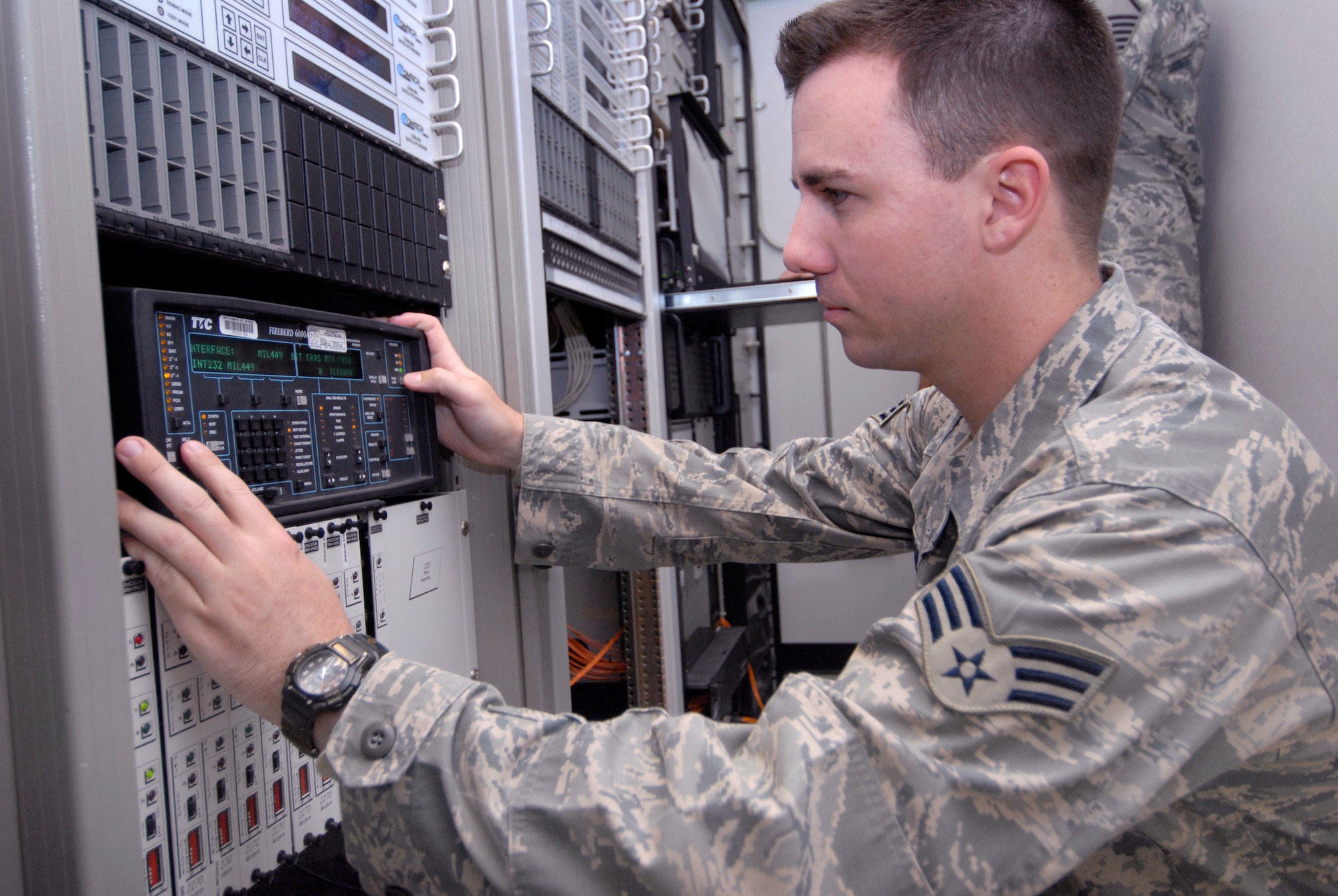 Senior Airman Jonathan Agee, a 379th Expeditionary Communications Squadron lead technician, checks equipment inside a Deployable KU Band Earth Terminal (DKET) by performing an air test on a circuit line, Mar. 30, 2009, at an undisclosed location in Southwest Asia.  The Tech Control personnel help provide 75% of the communication capability for the Air Force in the U.S. Central Command's Area of Responsibility.  Airman Agee hails from Yorba Linda, Calif. and is deployed from Yokota Air Base, Japan in support of Operations Iraqi and Enduring Freedom and Combined Joint Task Force - Horn of Africa.  (U.S. Air Force photo/Senior Airman Andrew Satran/released)