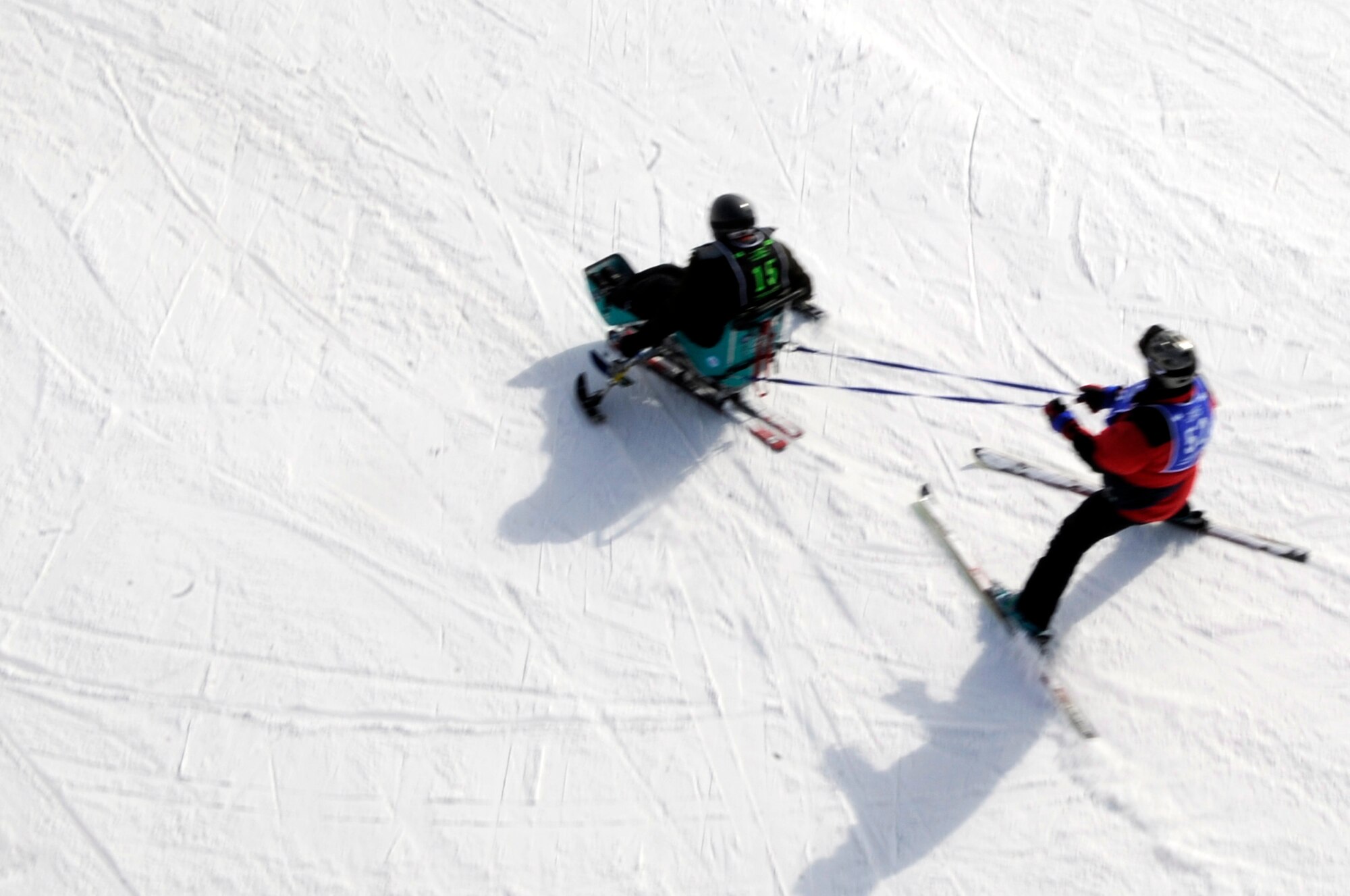 A veteran on a mono-ski starts down the slope while tethered to a ski instructor Mar. 31 during the 23rd National Disabled American Veterans Winter Sports Clinic in Snowmass Village, Colo.  (U.S. Air Force photo/Staff Sgt. Desiree N. Palacios)
