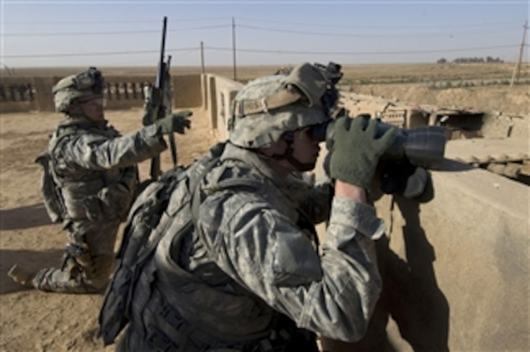 U.S. Army Cpl. Tim Garrett (left) and Spc. Jacob Collins from Recon Platoon, 1st Battalion, 24th Infantry Regiment, 1st Stryker Brigade Combat Team, 25th Infantry Division provide sniper over watch during the clearance of the village of Shuzayf, Iraq, on March 26, 2009.  