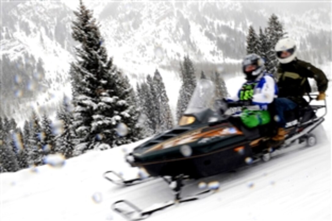 U.S. Air Force Senior Airman Kevin Krogh drives a snow mobile, April 1, 2009, during the 23rd National Disabled American Veterans Winter Sports Clinic in Snowmass Village, Colo. Krogh,  assigned to Fort Sam Houston in San Antonio, lost both legs in a major car accident in 2007.