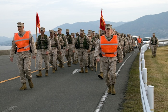 Marines of Marine Air Control Squadron 4 hump three miles before starting their Warrior’s Mess Night to strengthen ties and unwind at a warehouse north of Penny Lake here April 3. One of the debatable rumors on how Warrior’s Mess Night started in the Marine Corps is with Marines stationed in China during the Boxer Rebellion of 1900.