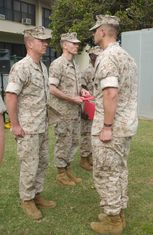 Lieutenant Col. Matt Baker, executive officer, 3rd Marine Regiment, (left) awards a Bronze Star Medal to Capt. James Marino, intelligence officer, 3rd Marines April 3. Marino was one of three medal recipients who deployed with Embedded Training Team 5-3 to mentor the Afghan National Army in 2008.