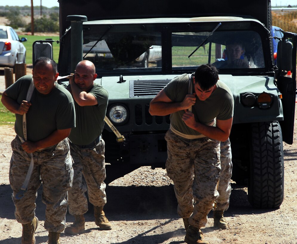 Marines from Marine Aircraft Group 13â??s Chemical, Biological, Radiological and Nuclear section pull a humvee at the MAG-13 Headquarters field meet held here Friday at Ramada Field. The MAG property section won the competition. The morale-boosting event provided an opportunity for competition between different MAG-13 Headquarters work sections and a cookout for the Marines and their families.