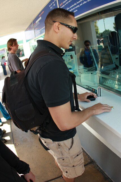 Lance Cpl. Aaron Kristopik, a paralegal clerk with the Combat Center’s Staff Judge Advocate and a native of New Britain, Conn., presents his military identification card to receive his free admission to SeaWorld in San Diego April 4.