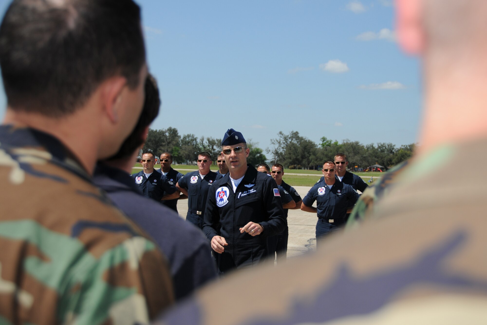Seven Keesler Airmen reenlisted alongside one of the F-16 Thunderbirds April 3 in advance of the the Thunder on the Bay Air Show April 4-5.  The Thunderbirds are making their first air show appearance at Keesler since 1994.  It’s Keesler’s first air show in five years.  (U.S. Air force photo by Kemberly Groue)