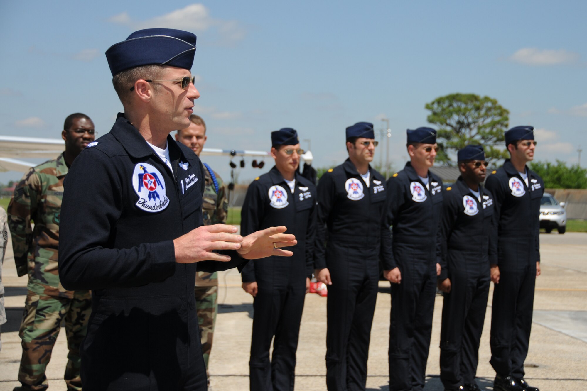 Seven Keesler Airmen reenlisted alongside one of the F-16 Thunderbirds April 3 in advance of the the Thunder on the Bay Air Show April 4-5.  The Thunderbirds are making their first air show appearance at Keesler since 1994.  It’s Keesler’s first air show in five years.  (U.S. Air force photo by Kemberly Groue)