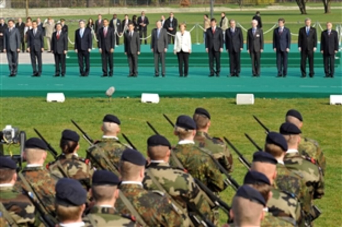 The NATO heads of state and government pay tribute to NATO military personnel for service in operational theatres of the alliance during an April 4, 2009, ceremony on the banks of the Rhine River between Strasbourg, France, and Kehl, Germany, during NATO's 60th anniversary summit. 