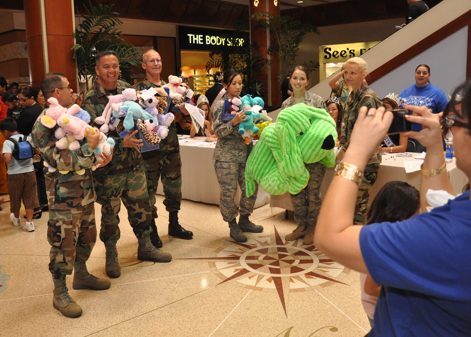 Members of the 624th Regional Support Group were treated like visiting celebrities when they brought in their donations of stuffed animals for the 12th Annual Teddy Bear Round-up and Family Resource Fair April 4 at Pearlridge Shopping Center, Aiea, Hawaii. The drive was in support of April Child Abuse Prevention Month. The 42 bears brought by the Air Force Reservists were added to a growing pile in the center of the mall that are destined to go to local children and families who are in crisis and in need of special attention. (Air Force photo/Master Sgt. Daniel Nathaniel)