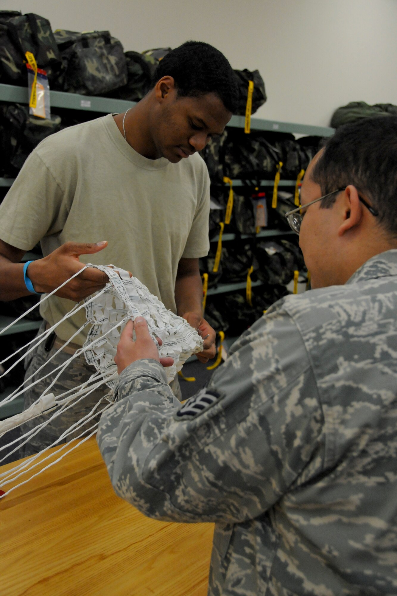 MISAWA AIR BASE, Japan -- Staff Sgt. Quinton Fitzgerald (left), air crew flight equipment craftsman, conducts his Advanced Concept Ejection Seat II drogue parachute re-certification March 26, 2009. Re-certifying him was Staff Sgt. James Reyes. Sergeants Fitzgerald and Reyes are both assigned to the 35th Operations Support Squadron. (U.S. Air Force photo by Senior Airman Jamal D. Sutter)