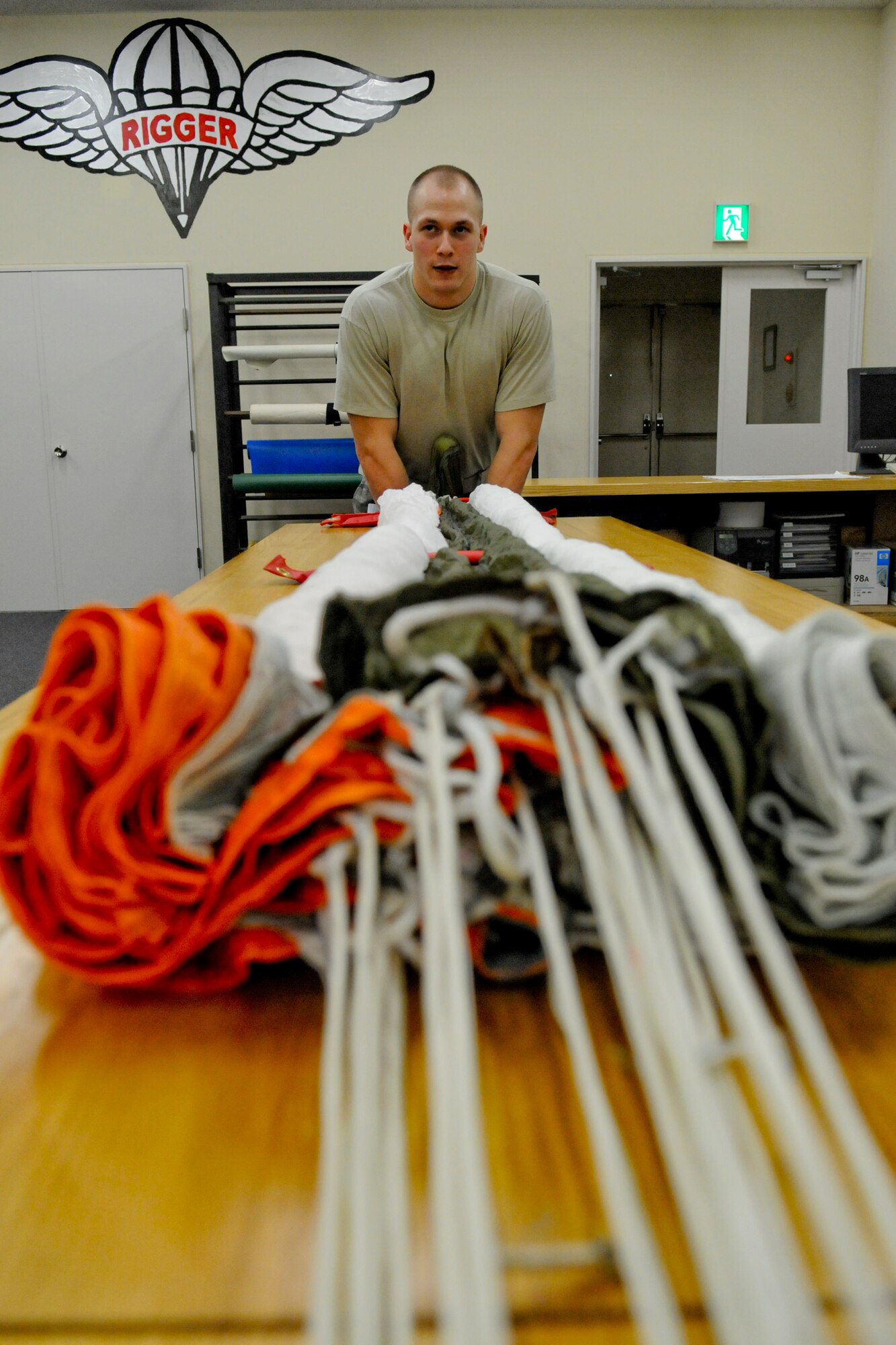MISAWA AIR BASE, Japan -- Airman 1st Class Carl Covington, 35th Operations Support Squadron air crew flight equipment journeyman, packs an Advanced Concept Ejection Seat II recovery parachute March 31, 2009. Airman Covington inspected and packed 16 parachutes before becoming eligible for certification. (U.S. Air Force photo by Senior Airman Jamal D. Sutter)