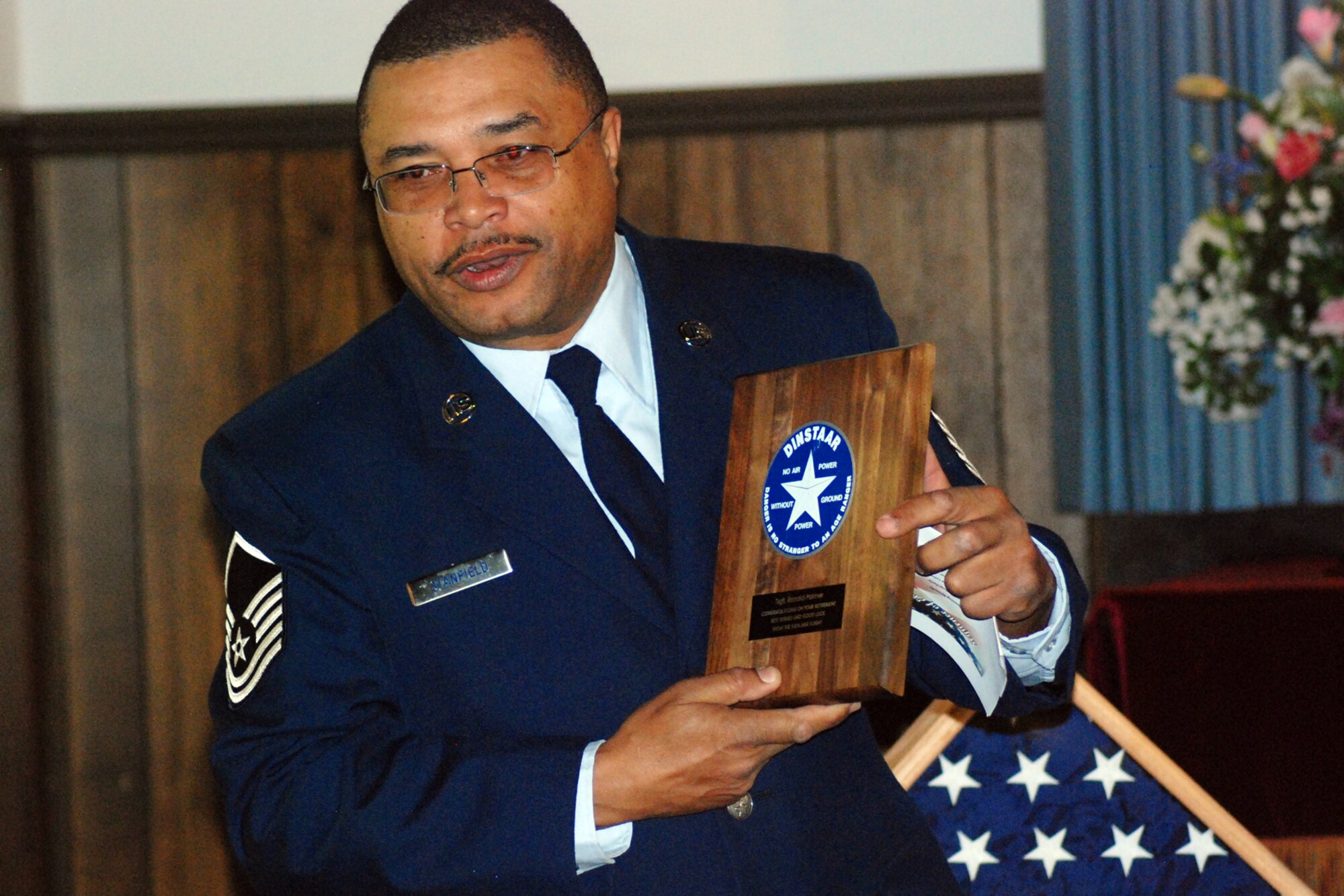 Master Sgt. Floyd Stanfield, 94th Aerospace Ground Equipment superintendent, gives words of thanks before his presentation of a plaque to Tech. Sgt. Robert Palmer, 94th AGE air reserve technician.  Sergeant Palmer retired during the April unit training assembly with more than 20-plus years of service.  (U.S. Air Force photo/Tech. Sgt. Robert Martin)