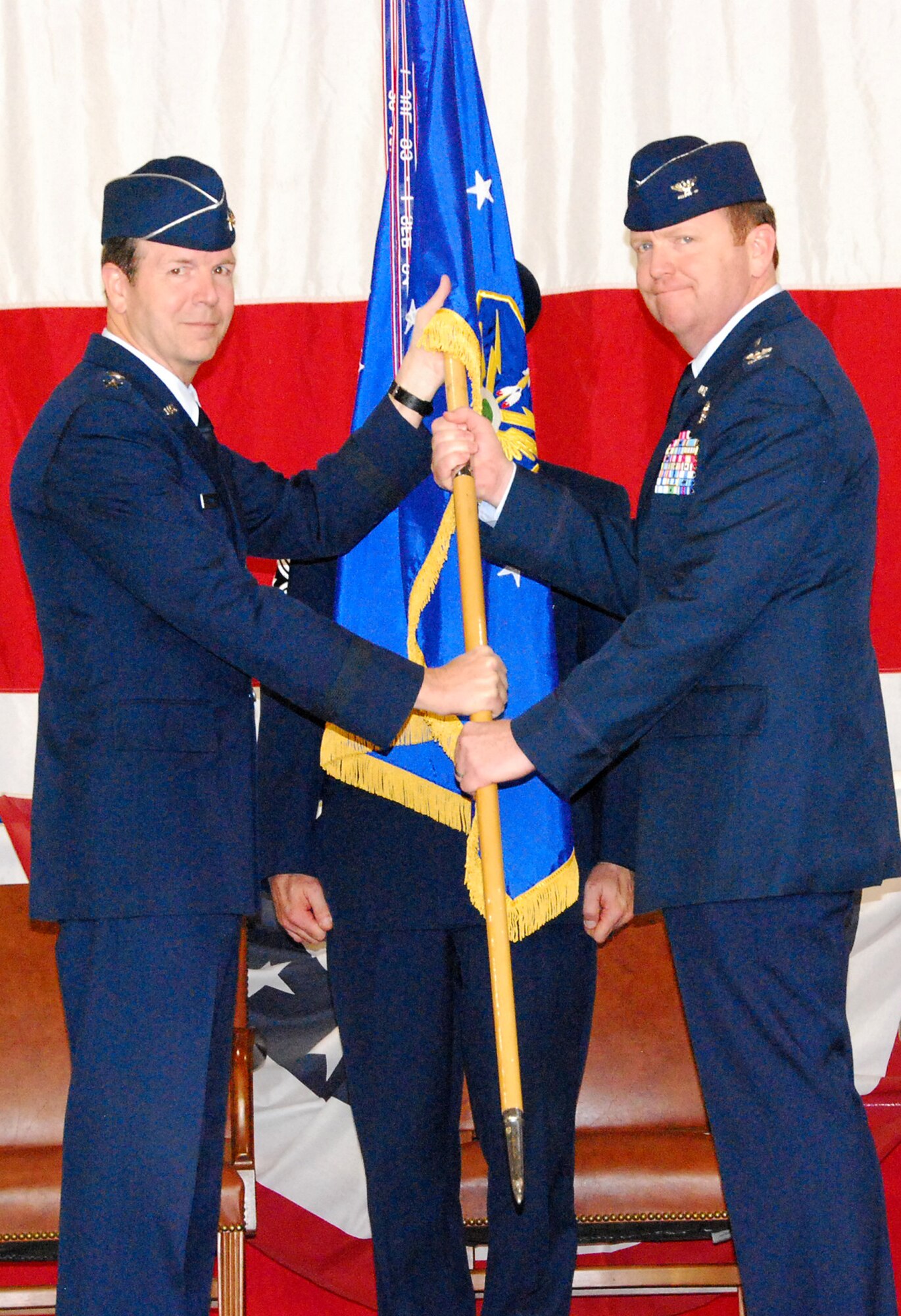 Maj. Gen. Thomas Coon, 10th Air Force commander, hands the 301st Fighter Wing command over to Col. Richard W. Scobee at Sunday's Change of Command ceremony. Col. Scobee comes to the Naval Air Station Joint Reserve Base Fort Worth, Texas, from the 944th Fighter Wing at Luke Air Force Base, Ariz. (U. S. Air Force Photo/Tech. Sgt. Julie Briden-Garcia)