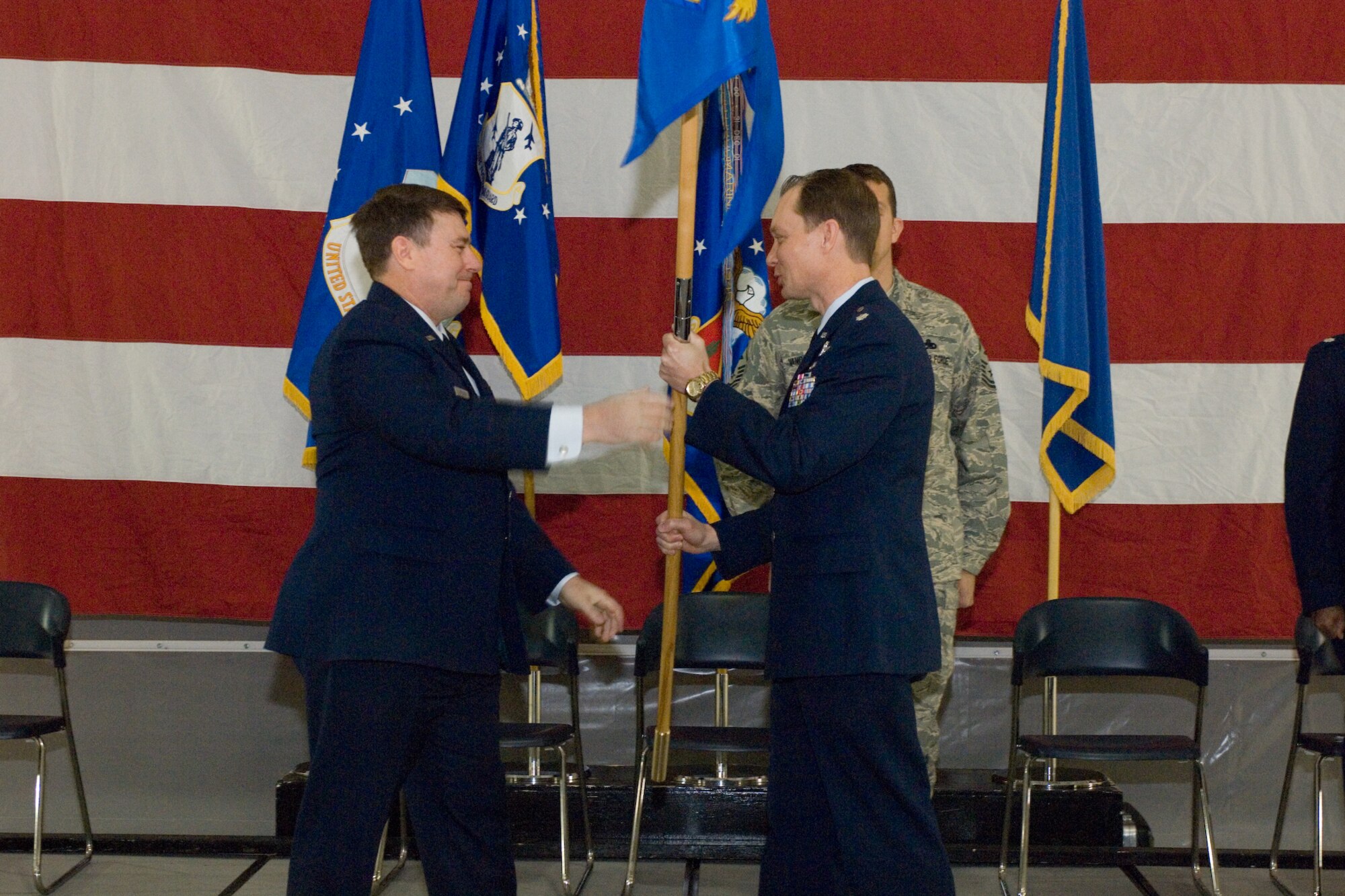 Brig. Gen. Michael Peplinski hands the 127th Maintenance Group Flag to Lt. Col. Gregory S. Holzhei during an April 4, 2009, assumption of command ceremony at Selfridge Air National Guard Base, Mich. Peplinski is the commander of the 127th Wing. Holzhei had recently been serving as the deputy commander for maintenance in the 127th Air Refueling Group, which is also at Selfridge. (U.S. Air Force photo by SrA. Jeremy Brownfield)