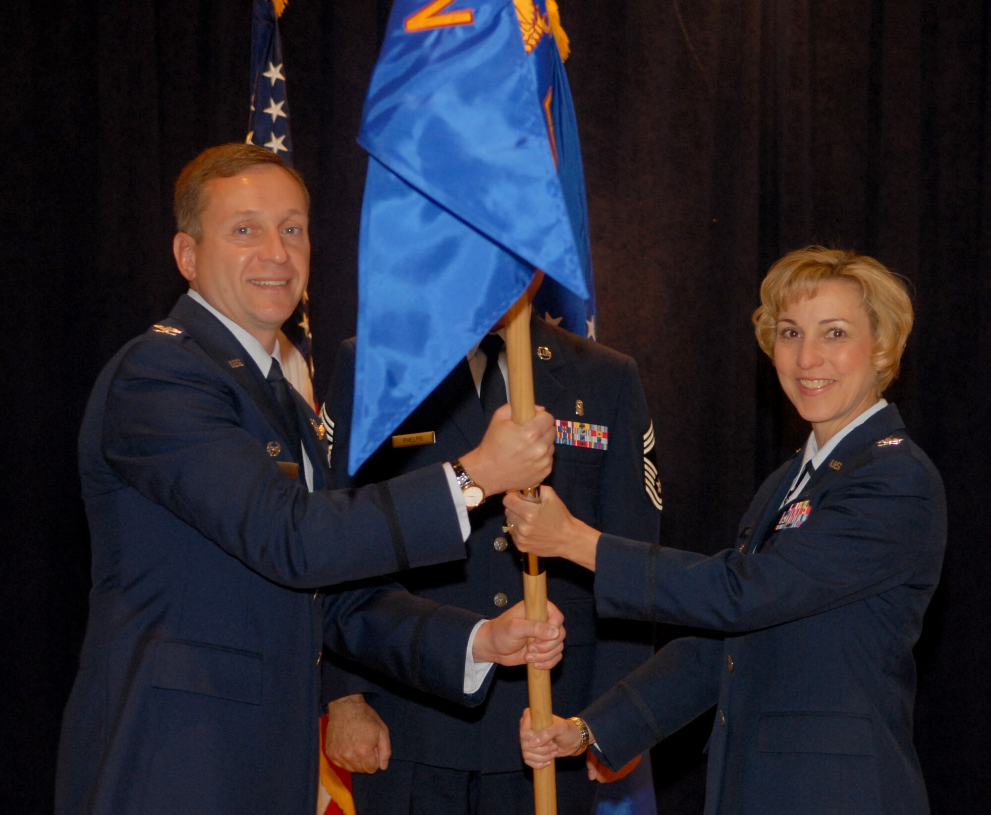 VANDENBERG AIR FORCE BASE, Calif. -- Col. Janice Wallace receives the 30th Medical Group guidon from Col. David Buck, 30th Space Wing commander, as she assumes command of the group March 30 at a ceremony at the Pacific Coast Club here. Colonel Wallace arrived at Vandenberg after being the deputy commander of the 45th Medical group at Sheppard Air Force Base, Texas.(Air Force Photo/Airman 1st Class Antionette Lyons)